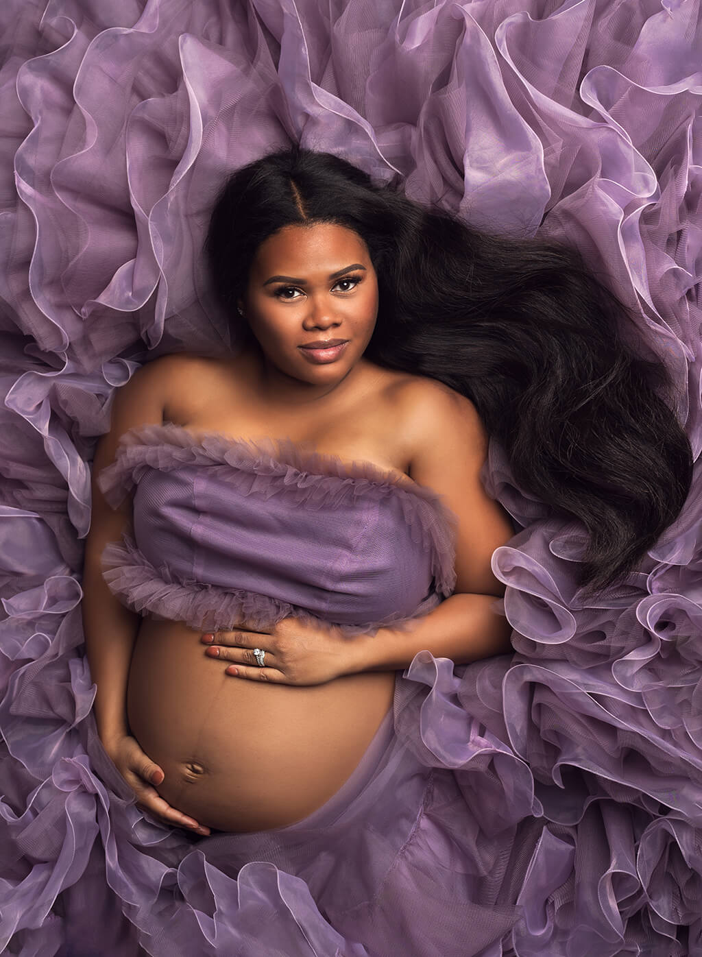 Gorgeous maternity Photography: a pregnant mommy posing her baby belly at a photography studio in Palm City Florida