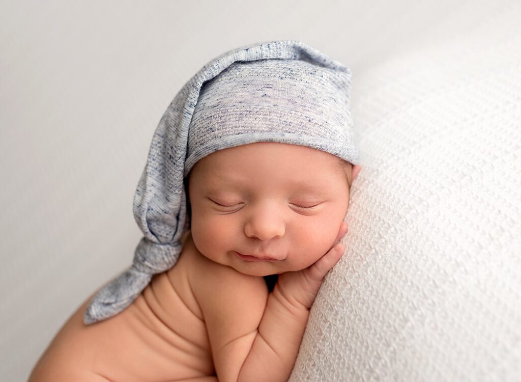 Close-up of a newborn boy posing with adorable innocence in a Stuart, Florida studio.