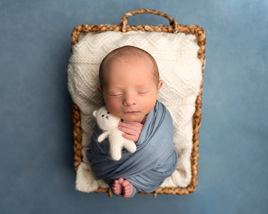 Newborn baby boy wrapped in a cozy blanket during a Stuart, Florida studio session.