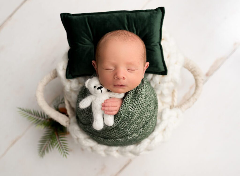 Sweet cuddle moment with a baby boy in a soft blanket during a Stuart, Florida studio session.